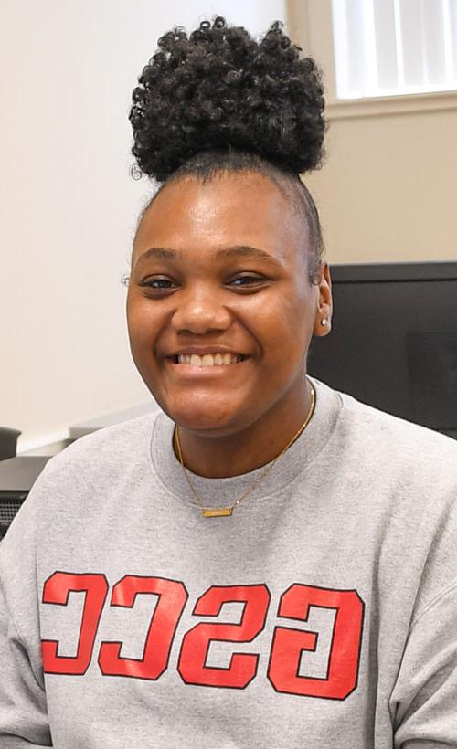 Student wearing GSCC sweater smiling